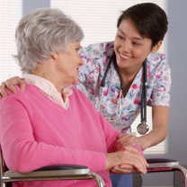 caregiver talking to a senior on wheelchair