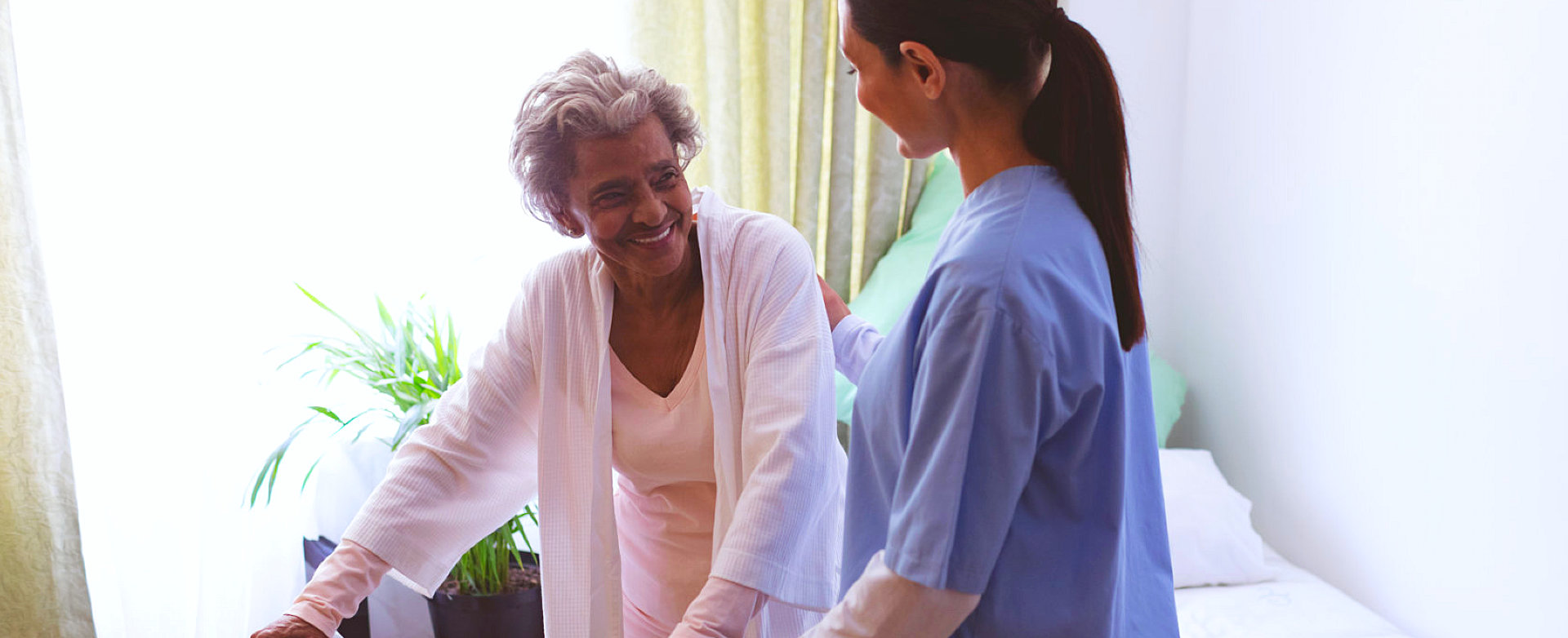 senior woman smiling to caregiver