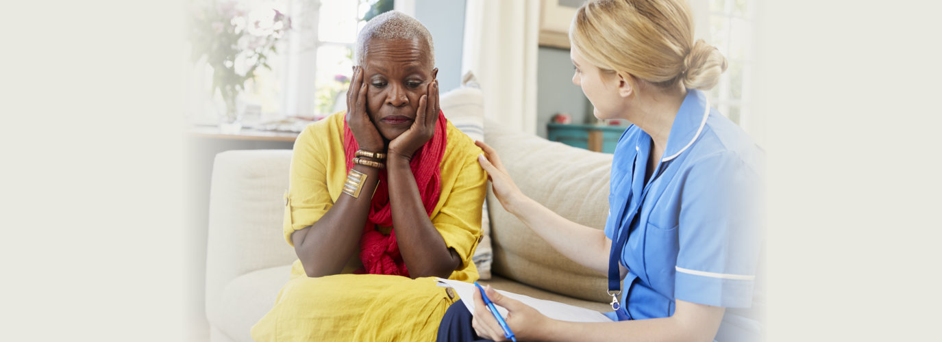 community nurse visits senior woman suffering with depression. female, grief.