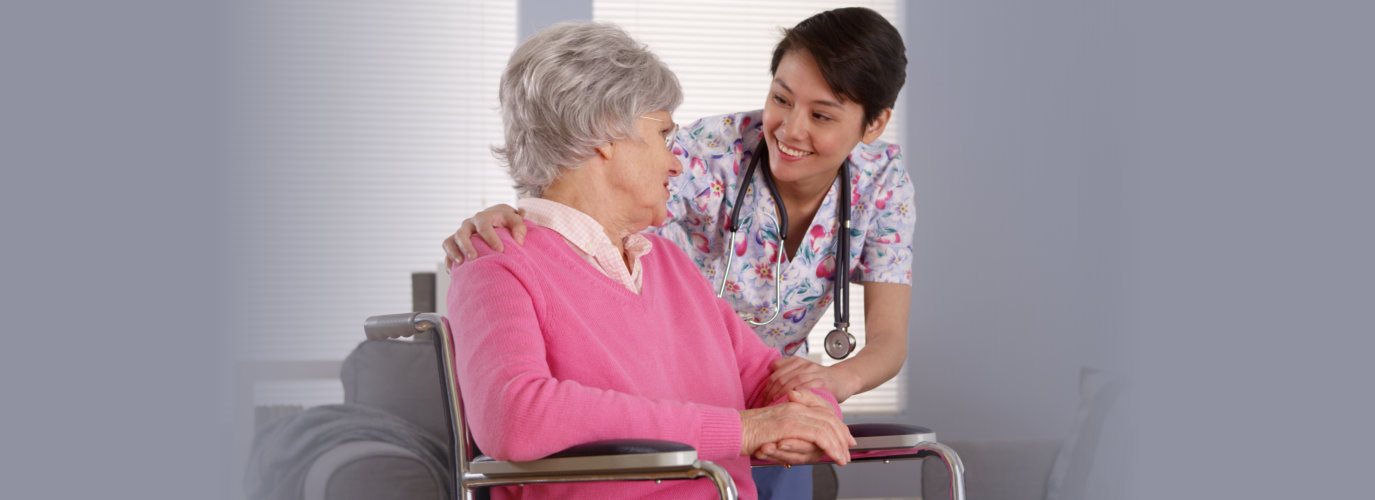 Chinese nurse talking with senior patient.